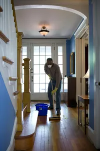 Image of person cleaning a hallway floor